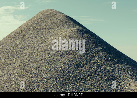 A large gravel pile, material used for construction and maintaining roads. Stock Photo