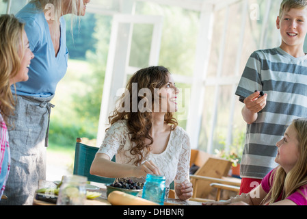Farmhouse in the country in New York State. Four generations of women in a family baking cookies and apple pie. Stock Photo