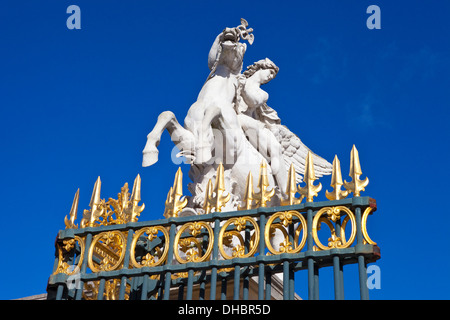 A statue above the main entrance to Tuileries Garden in Paris. Stock Photo