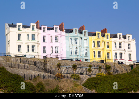 Pastel coloured hotel frontages in a terraced row on the Esplanade at Tenby, Pembrokeshire, Wales, UK