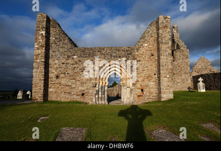 The shadow of High Cross and St Ciaren's 6th Century Romanesque Cathedral door, Clonmacnoise, County Offaly, Ireland Stock Photo