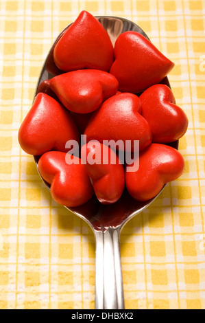 many valentine hearts in a spoon, spoon full of love Stock Photo