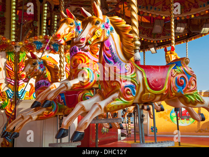 Fairground ride horses on a merry go round with nobody on it Stock Photo