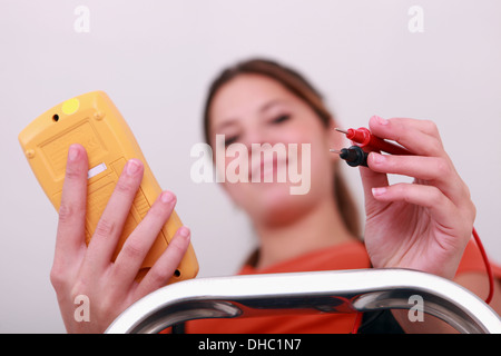 Happy female laborer using multimeter Stock Photo