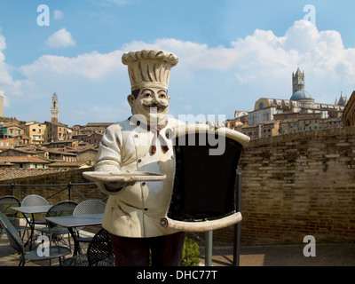 Figure of an Italian chef with the Siena´s panoramic view on his back. Siena, Italy Stock Photo