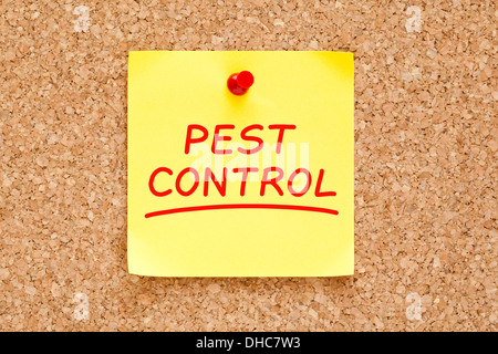 Pest Control on yellow sticky note pinned with red push pin on cork board. Stock Photo