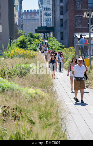 Pedestrians walk along the High Line in New York, New York on October ...
