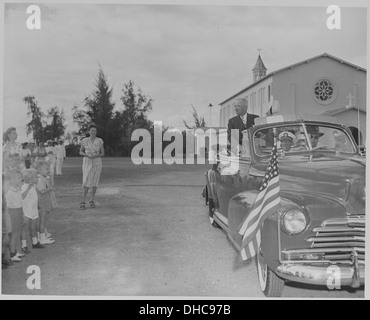 Photograph of President Truman riding in his automobile past a group of school children during his visit to the U.S.... 200485 Stock Photo