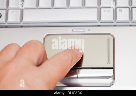 Technology using a laptop, Male finger on touchpad. Computer work Stock Photo
