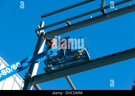 Steel erector workman on an access platform, 1 Hardman Street site, Spinningfields, Manchester, England, UK Stock Photo
