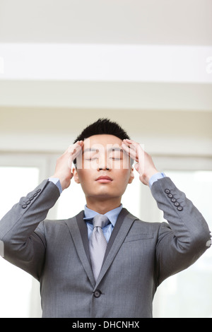 Portrait of young businessman got a headache Stock Photo