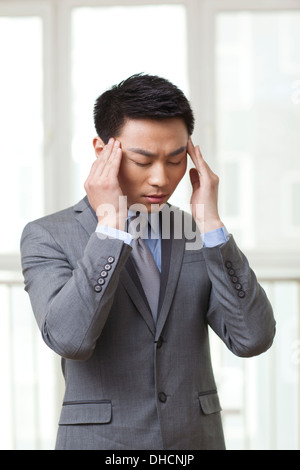 Portrait of young businessman got a headache Stock Photo