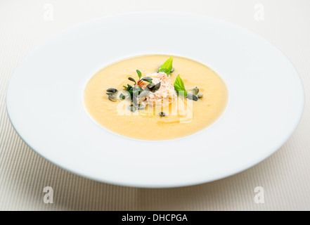 Pumpkin crab soup on a white bowl Stock Photo