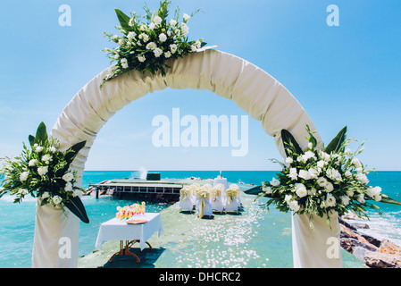 Wedding arch and wedding chairs on the empty beach Stock Photo