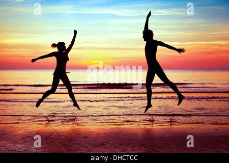 happiness, couple jumping on the beach Stock Photo