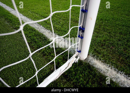 A view of a goalpost and goal net on a football pitch Stock Photo