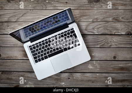 laptop on old wooden desk Stock Photo