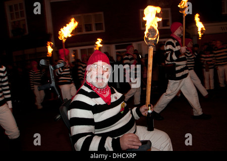 Lewes, Sussex. Bonfire Night November 5th 2013. Cliffe Bonfire Society members parade including John Russell in his wheelchair. Stock Photo