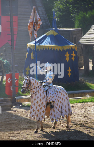 The Story of the Lance Medieval re enactment with a knight on horse back in full armour  Puy Du Fou France Stock Photo