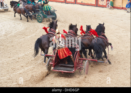 Roman Chariot Race re-enactment in the amphitheatre at Puy Du Fou France Stock Photo