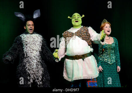 Duesseldorf, Germany. 07th Nov, 2013. The performer Andreas Wolfram (L-R) dressed as a donkey, Frank Winkels as Shrek and Jana Stelley as Fiona pose on the stage during the casting for the musical 'Shrek' in the Capitol Theatre in Duesseldorf, Germany, 07 November 2013. The hero Shrek and his princess Fiona fascinated an audience of millions in the cinemas worldwide. In October 2014 the musical celebrates its premiere in the Capitol Theatre in Duesseldorf. Photo: HORST OSSINGER/dpa/Alamy Live News Stock Photo