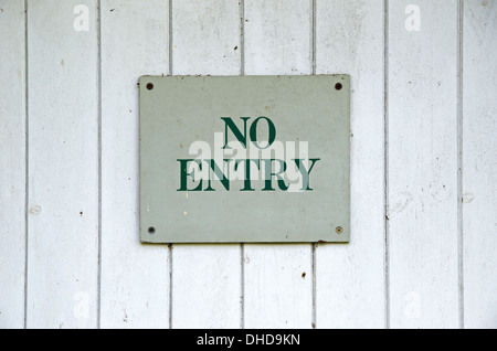 Weathered no entry sign on panelled door Stock Photo