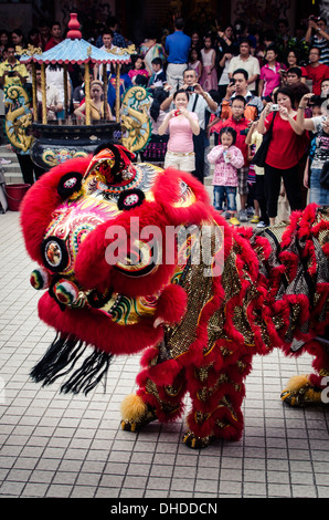 A traditional lion dance during Chinese New Year celebrations, Thean Hou Temple, Kuala Lumpur, Malaysia, Southeast Asia, Asia Stock Photo