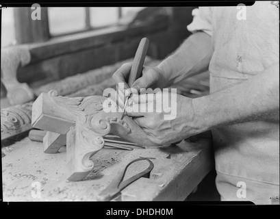 A close-up of a hand carver at Tomlinson Chair Manufacturing Co. in High Point, North Carolina, capturing the craftsmanship involved in chair upholstering. Stock Photo