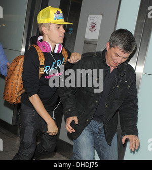 BIEBER'S AIRPORT CLASH AFTER FLEEING MOB JUSTIN BIEBER clashed an onlooker as he fled mob of screaming girls in U.K Stock Photo