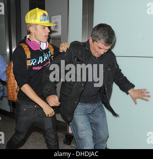 BIEBER'S AIRPORT CLASH AFTER FLEEING MOB JUSTIN BIEBER clashed an onlooker as he fled mob of screaming girls in U.K Stock Photo