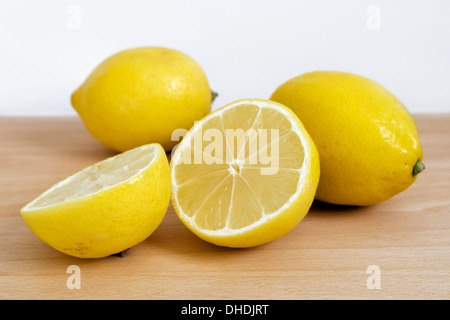 Fresh lemons on chopping board Stock Photo