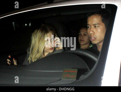 Riley Keough chats on her mobile phone in car as she leaves Chateau