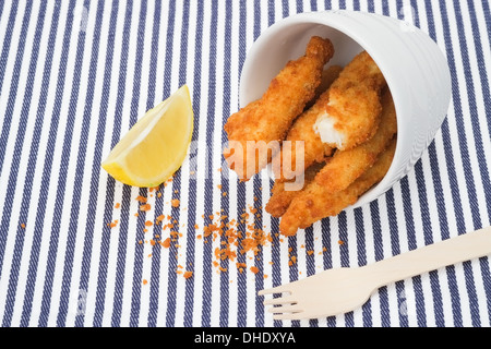 Deep fried fish finger sticks and a wedge of lemon Stock Photo