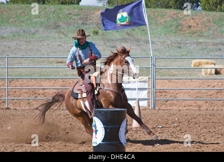 Cowboy with gun on horse, mounted shooting competition, End of Trail Wild West Jubilee, near Albuquerque, New Mexico USA Stock Photo