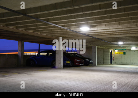 Cars parked in a multi storey car park at night Stock Photo