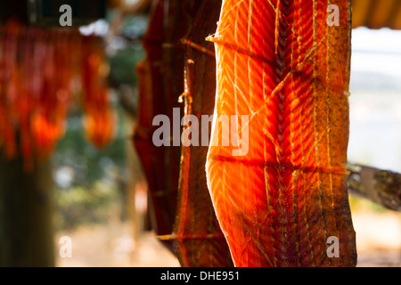 Meat is cut and hanged to dry outdoors in the lodge Stock Photo