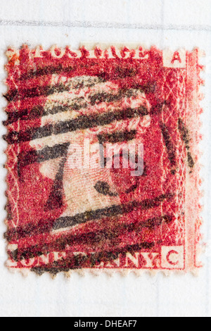 Victorian British stamp with Queen Victoria portrait, 1d, penny red, circa 1850. Cancellation mark on stamp is an oval with 75 in the centre. Stock Photo