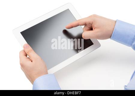 Man's hands are holding a tablet computer and points a finger at the screen on a white background. Stock Photo