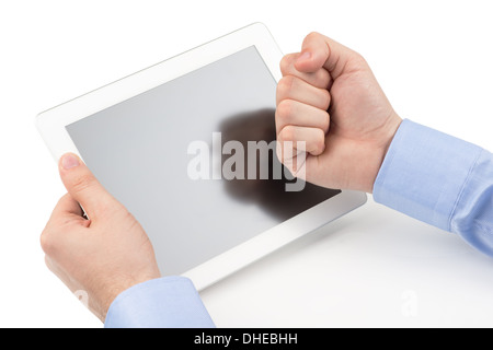 Mans hands holding a tablet computer and threatening by a fist at the screenn on a white background. Stock Photo
