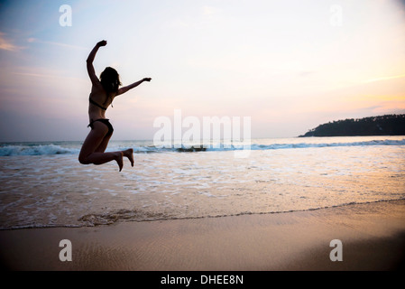 Tourist jumping on Mirissa Beach at sunset, South Coast of Sri Lanka, Southern Province, Sri Lanka, Asia Stock Photo