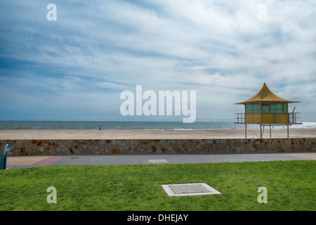 Lifeguards watch out from a surf life saving tower on an Australian beach in Glenelg, Adelaide. Stock Photo