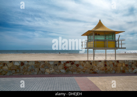 Lifeguards watch out from a surf life saving tower on an Australian beach in Glenelg, Adelaide. Stock Photo