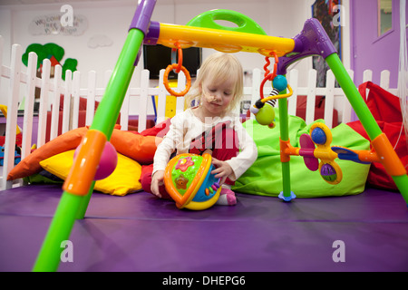 A young girl enjoys the playroom at a hospital UK Stock Photo