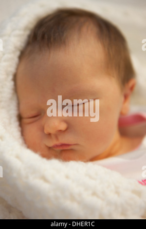 A newborn baby girl sleeps in her cot in the Luton and Dunstable hospital where she was born UK Stock Photo