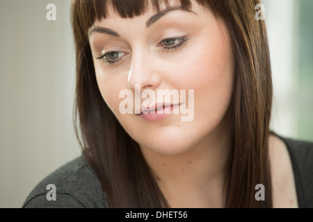 Young woman looking down Stock Photo