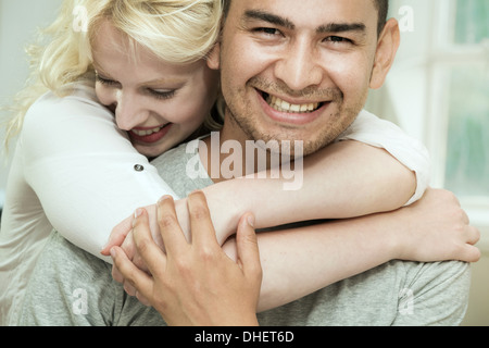 Young woman hugging boyfriend Stock Photo