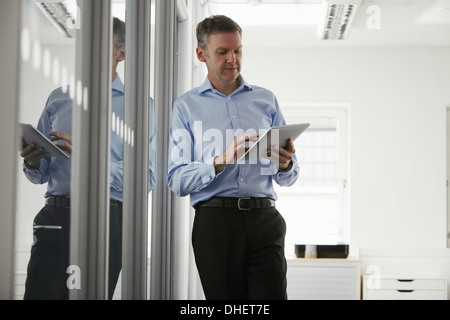 Man using digital tablet in office Stock Photo