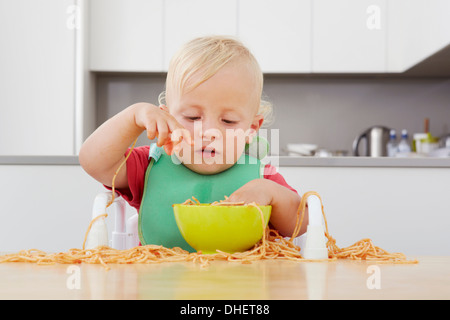 Toddler playing with spaghetti Stock Photo