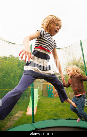 Girls jumping on trampoline Stock Photo