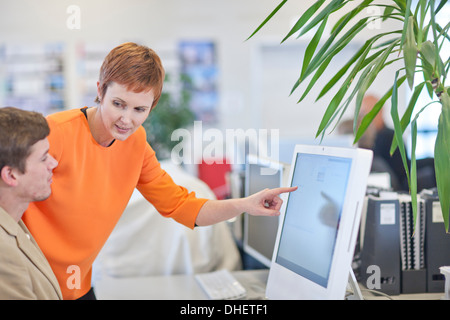 Businesspeople using computer Stock Photo